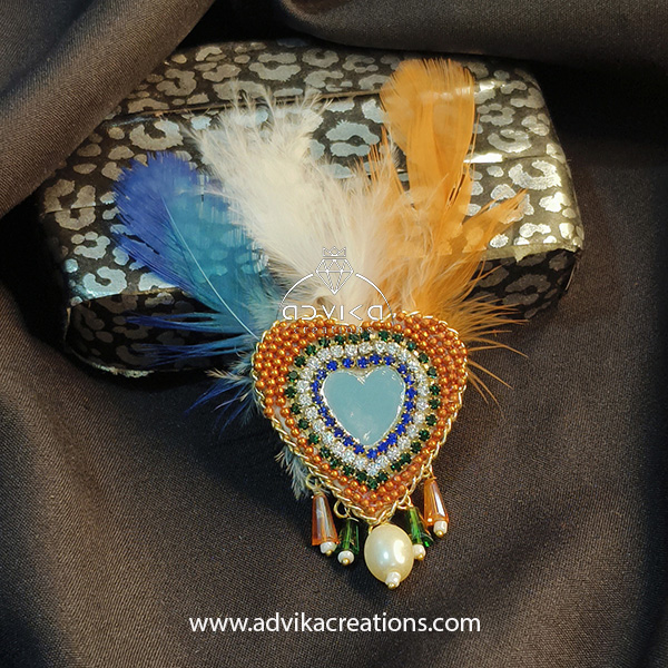 Heart shape brooch with colorful feather