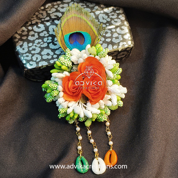 flower brooch with peacock feather
